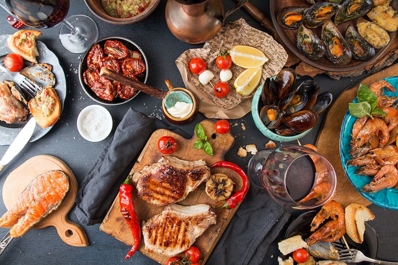 Overhead-of-dinner-table.-Barbecue-meat-and-seafood-with-vegetable